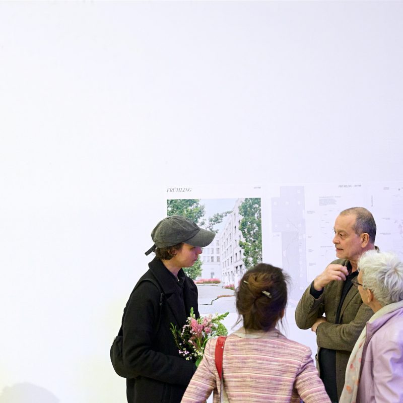 Preisträgerin mit Gästen bei Ausstellung der Wettbewerbsbeiträge